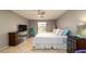 Bright bedroom featuring neutral walls, a ceiling fan, tile flooring, and closet space at 5859 Lincoln Rd, Venice, FL 34293