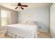 Bedroom with tile flooring, ceiling fan, light blue walls, and a closet at 5859 Lincoln Rd, Venice, FL 34293