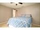 Cozy bedroom featuring tile floors, ceiling fan, and closet doors at 5859 Lincoln Rd, Venice, FL 34293