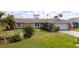 Charming single-story home features a well-manicured lawn and tropical landscaping at 5859 Lincoln Rd, Venice, FL 34293