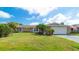 Charming single Gathering home with a well manicured lawn, beautiful plants and a two-car garage at 5859 Lincoln Rd, Venice, FL 34293