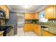 Spacious kitchen with stainless appliances and light wood cabinets at 5859 Lincoln Rd, Venice, FL 34293