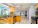 Well-lit kitchen featuring tile floors and light wood cabinets at 5859 Lincoln Rd, Venice, FL 34293