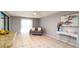 Bright living room featuring tile flooring, neutral walls, and an airy ceiling fan at 5859 Lincoln Rd, Venice, FL 34293