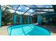 Screened-in pool featuring a ladder, surrounding patio, and view of the house at 5859 Lincoln Rd, Venice, FL 34293