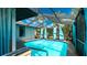 Screened-in pool featuring a ladder, surrounding patio, and view of the house at 5859 Lincoln Rd, Venice, FL 34293