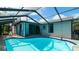 Screened-in pool featuring a ladder, surrounding patio, and view of the house at 5859 Lincoln Rd, Venice, FL 34293