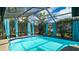 Sparkling screened-in pool with bright blue curtains offers a private and refreshing outdoor space at 5859 Lincoln Rd, Venice, FL 34293