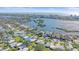 This aerial captures a residential neighborhood with waterfront views and lush green spaces at 5869 Tidewood Ave # 7, Sarasota, FL 34231
