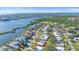 Overhead shot of a waterfront neighborhood, revealing the scenic river and cityscape along the horizon at 5869 Tidewood Ave # 7, Sarasota, FL 34231
