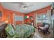 Vibrant bedroom featuring a sitting area, hardwood floors, and sun-drenched windows at 5869 Tidewood Ave # 7, Sarasota, FL 34231