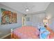 Bright bedroom with colorful artwork, coastal themed pillows, and a ceiling fan at 5869 Tidewood Ave # 7, Sarasota, FL 34231