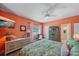 Warm bedroom with a floral bedspread, an armoire and an en suite bathroom at 5869 Tidewood Ave # 7, Sarasota, FL 34231