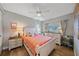 Bright bedroom with white furniture, wood floors and tropical themed decor at 5869 Tidewood Ave # 7, Sarasota, FL 34231