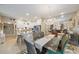 Open-concept dining area with a glass table, wicker chairs, and an elegant chandelier, perfect for gatherings and meals at 5869 Tidewood Ave # 7, Sarasota, FL 34231