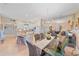 Bright dining room featuring a glass table, wicker chairs, a decorative chandelier and mirrored wall at 5869 Tidewood Ave # 7, Sarasota, FL 34231