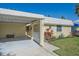 Charming single-story home featuring a carport, well-maintained landscaping, and a bright, welcoming facade at 5869 Tidewood Ave # 7, Sarasota, FL 34231