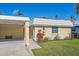 Cozy single-story home with a well-maintained lawn and an attached carport at 5869 Tidewood Ave # 7, Sarasota, FL 34231