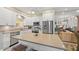Well-appointed kitchen features stainless appliances, white cabinets, and a spacious island with seating, ideal for cooking and gathering at 5869 Tidewood Ave # 7, Sarasota, FL 34231