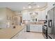 Bright kitchen featuring stainless appliances, white cabinetry, and ample counter space, perfect for culinary creations and entertaining at 5869 Tidewood Ave # 7, Sarasota, FL 34231