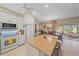 Open-concept kitchen featuring white cabinetry, an island, and seamless connection to the living spaces at 5869 Tidewood Ave # 7, Sarasota, FL 34231