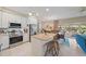 Bright kitchen features stainless appliances, a kitchen island with seating, and an adjacent dining area with ample natural light at 5869 Tidewood Ave # 7, Sarasota, FL 34231
