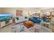 Inviting living room with stylish furniture, a vibrant rug, and an open view of the kitchen and dining area at 5869 Tidewood Ave # 7, Sarasota, FL 34231