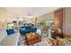 Comfortable living room with stylish furniture, a colorful rug, and an open layout leading to the dining area and kitchen at 5869 Tidewood Ave # 7, Sarasota, FL 34231