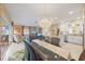 Bright living space featuring stylish furnishings, a modern kitchen, and a beautiful crystal chandelier at 5869 Tidewood Ave # 7, Sarasota, FL 34231