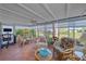 Bright sun room with ample windows offering great views, cozy seating, and tile flooring at 5869 Tidewood Ave # 7, Sarasota, FL 34231