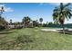 A large grassy backyard with mature trees at 605 15Th Avenue E Dr, Palmetto, FL 34221