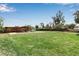 Large grassy backyard features a covered patio and mature trees at 605 15Th Avenue E Dr, Palmetto, FL 34221
