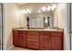 This bathroom features double sinks, spacious wood cabinets, and ample counter space at 605 15Th Avenue E Dr, Palmetto, FL 34221