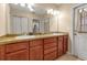 Bathroom vanity with double sinks, tile floors, and neutral walls with mirror at 605 15Th Avenue E Dr, Palmetto, FL 34221
