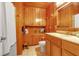 Bathroom with wood paneling, vanity, and updated fixtures at 605 15Th Avenue E Dr, Palmetto, FL 34221