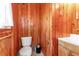 Bathroom with wood paneling, toilet, and vanity sink at 605 15Th Avenue E Dr, Palmetto, FL 34221
