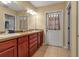 Bathroom vanity with double sinks, tile floors, and neutral walls with mirror at 605 15Th Avenue E Dr, Palmetto, FL 34221