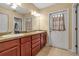 Bathroom boasts double sinks with wood cabinets and an exterior door for added convenience at 605 15Th Avenue E Dr, Palmetto, FL 34221