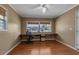 Neutral room with hardwood floors, windows, a built-in desk, chair and a ceiling fan with light at 605 15Th Avenue E Dr, Palmetto, FL 34221