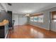 Bright dining area featuring hardwood floors, neutral paint, and a window with a peaceful neighborhood view at 605 15Th Avenue E Dr, Palmetto, FL 34221