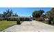 Well-kept single story home featuring a paved driveway and decorative brick columns at 605 15Th Avenue E Dr, Palmetto, FL 34221