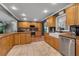 Kitchen with granite counters, farmhouse sink, stainless steel appliances, and wood cabinets at 605 15Th Avenue E Dr, Palmetto, FL 34221