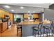 Kitchen with stainless steel appliances, wooden cabinets, granite countertop, and a breakfast bar at 605 15Th Avenue E Dr, Palmetto, FL 34221
