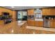 Open concept kitchen with granite countertops, stainless steel appliances, and view into living area at 605 15Th Avenue E Dr, Palmetto, FL 34221