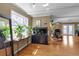 Bright living room featuring hardwood floors, large windows, plants, and a modern design at 605 15Th Avenue E Dr, Palmetto, FL 34221