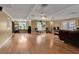 Spacious living room with hardwood floors, ceiling fan, and plenty of room for entertaining at 605 15Th Avenue E Dr, Palmetto, FL 34221