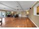 Large living room with hardwood floors, ceiling fan, and double doors to the outside at 605 15Th Avenue E Dr, Palmetto, FL 34221