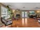 Bright living room featuring hardwood floors, double doors leading to the backyard, and comfortable seating at 605 15Th Avenue E Dr, Palmetto, FL 34221