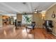 Bright living room with hardwood floors, neutral walls, modern seating, and a view of the kitchen at 605 15Th Avenue E Dr, Palmetto, FL 34221