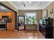Open concept living room featuring hardwood floors, large windows and an open view of the kitchen at 605 15Th Avenue E Dr, Palmetto, FL 34221